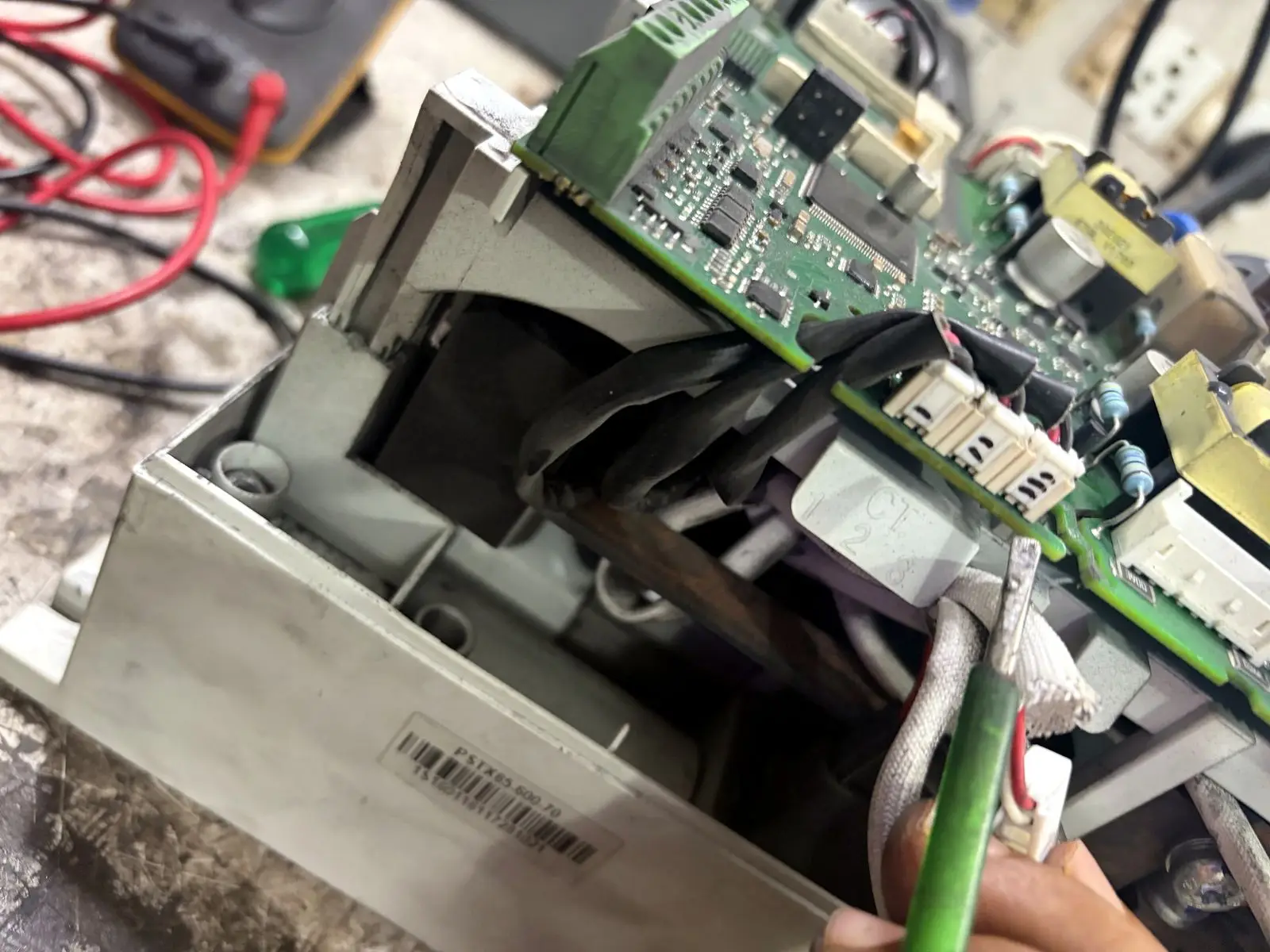 Technician dismantling a drive to reach the power board
